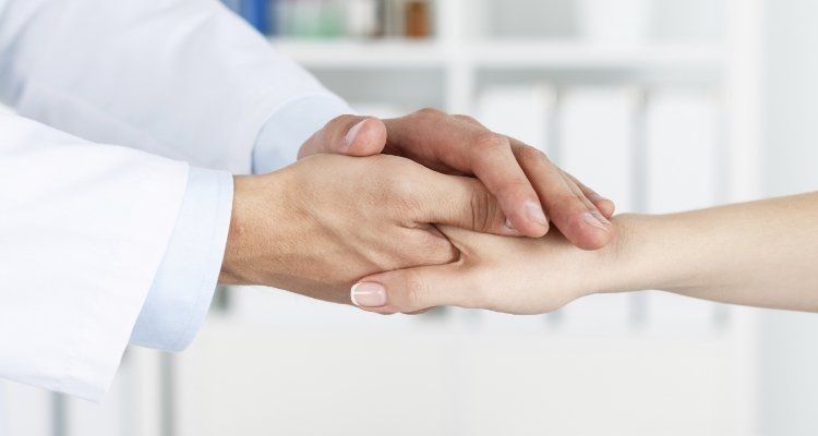 Medical professional shaking hands with a patient