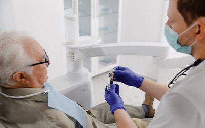 a dentist explaining dental implants to a patient