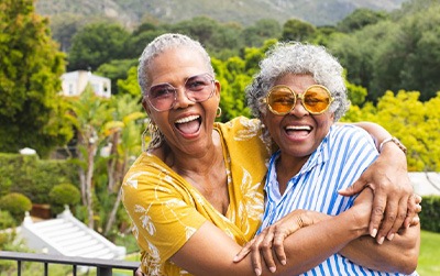 Two women laughing as they enjoy time outdoors