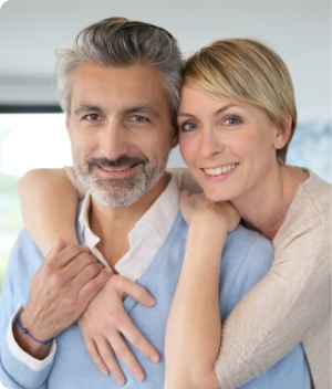 woman holding invisalign and smiling