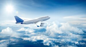 Blue and white plane in a cloudy sky