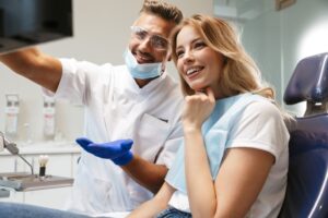 Dentist and patient reviewing X-ray together